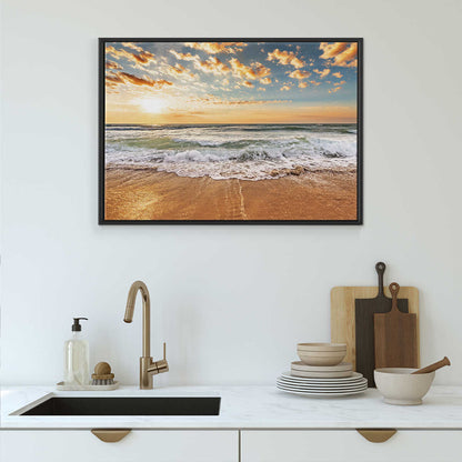 Framed beach sunset art above a kitchen sink with utensils.
