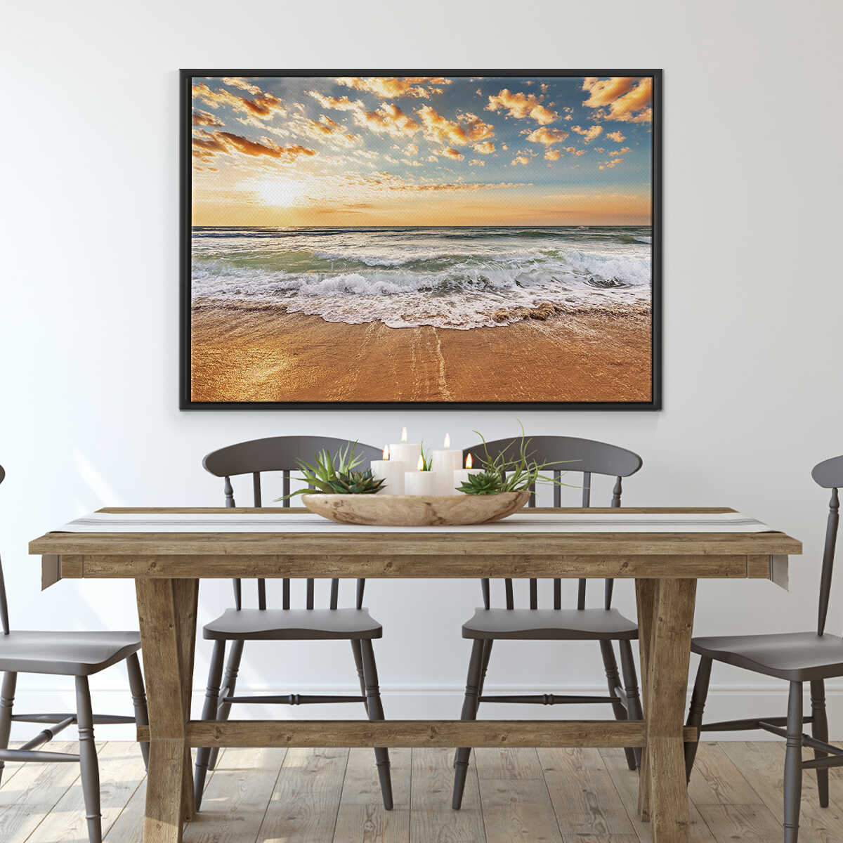 Dining room with a wooden table and chairs, featuring a large framed beach scene on the wall.