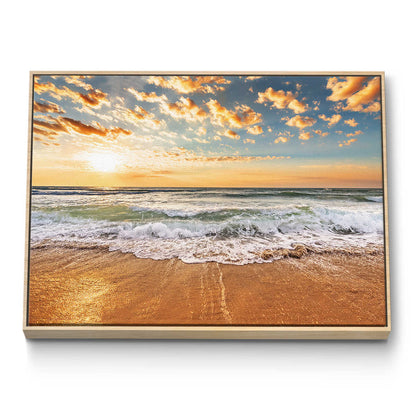 Framed artwork of a beach scene with sunset over the ocean.