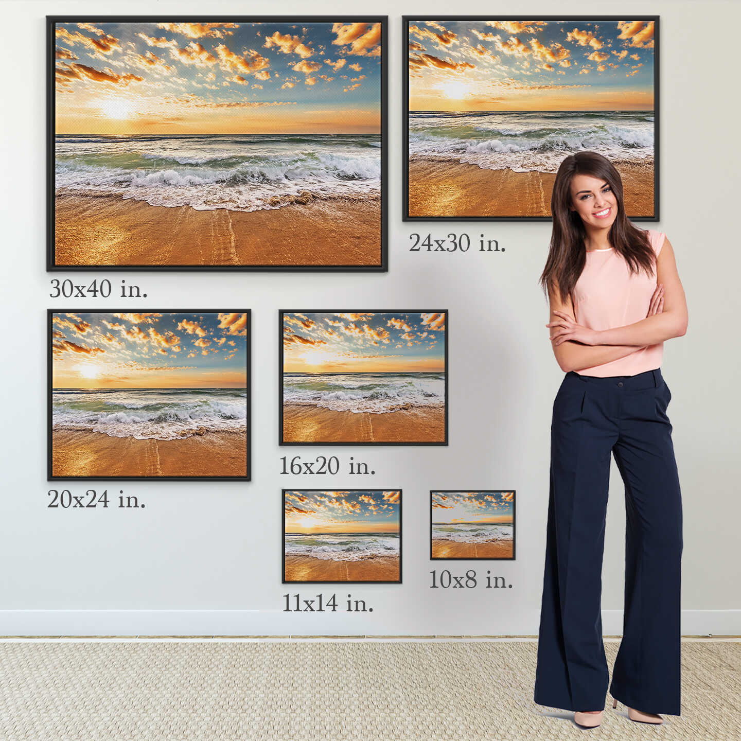 Woman standing next to various sizes of beach scene wall art